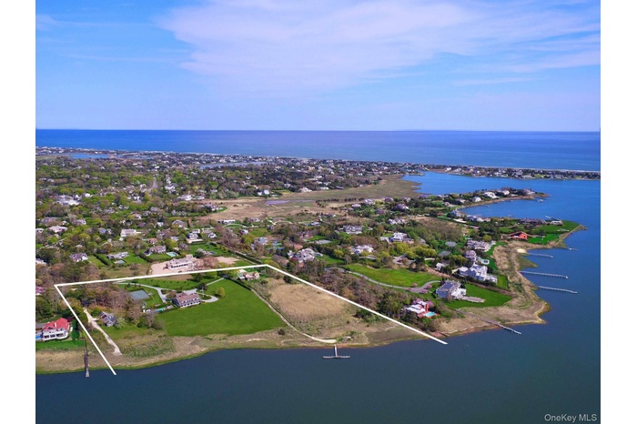 Aerial view of property's location featuring a large body of water and property parcel outlined