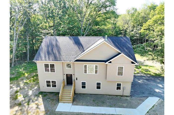 Split foyer home featuring roof with shingles