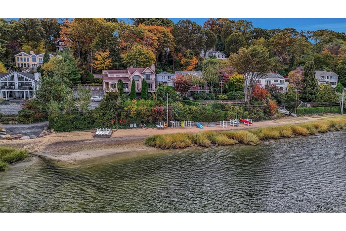 View of subject property featuring a nearby body of water and a tree filled landscape