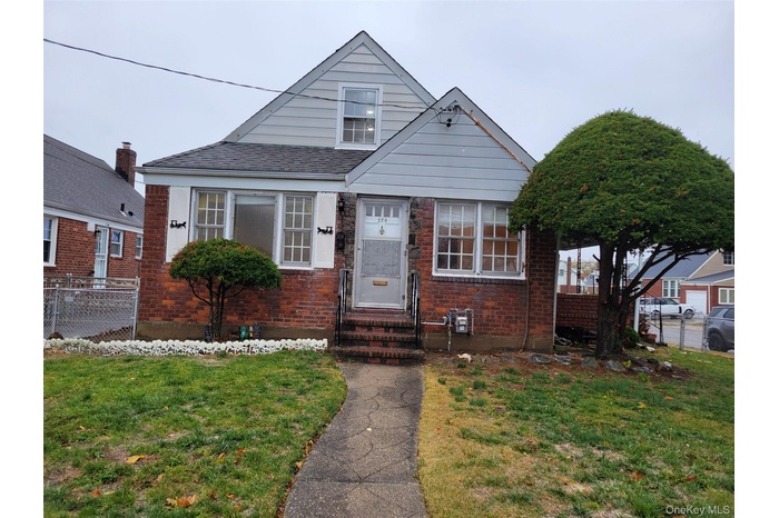 Bungalow-style house featuring brick siding and entry steps