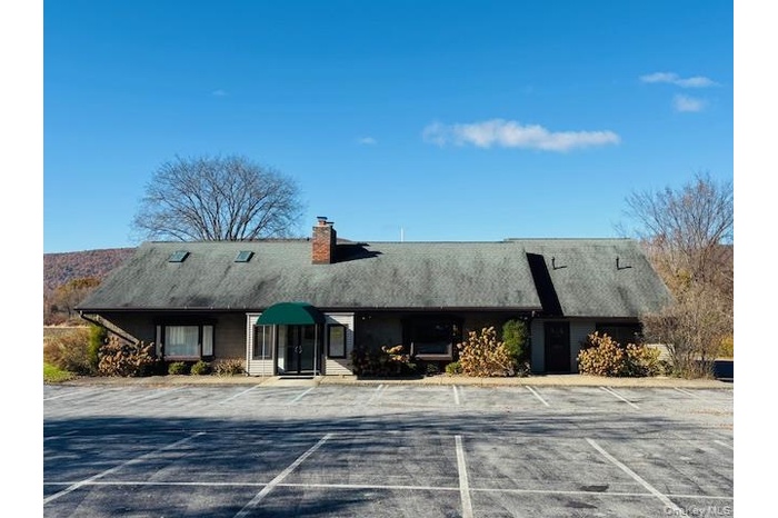 View of property with uncovered parking