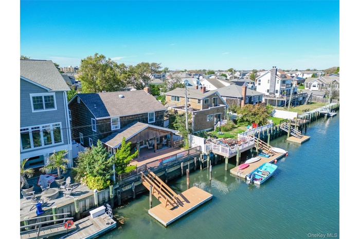 Aerial perspective of suburban area featuring a large body of water