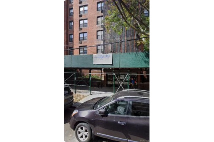 View of apartment building / complex with parking