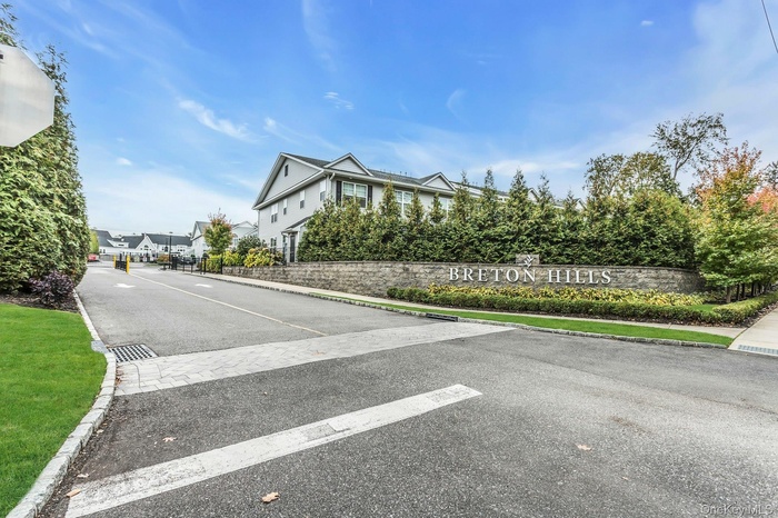 View of asphalt road featuring curbs, sidewalks, and a residential view