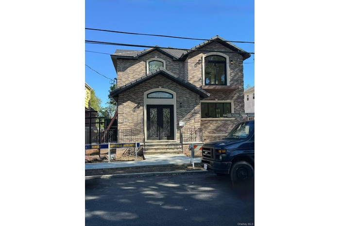 View of front of house with brick siding and french doors