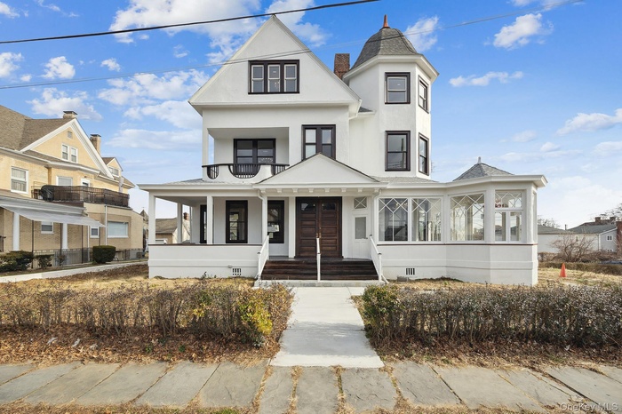 Victorian home featuring stucco siding, crawl space, and a porch
