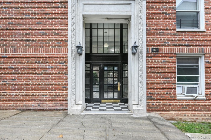 Entrance to property with brick siding