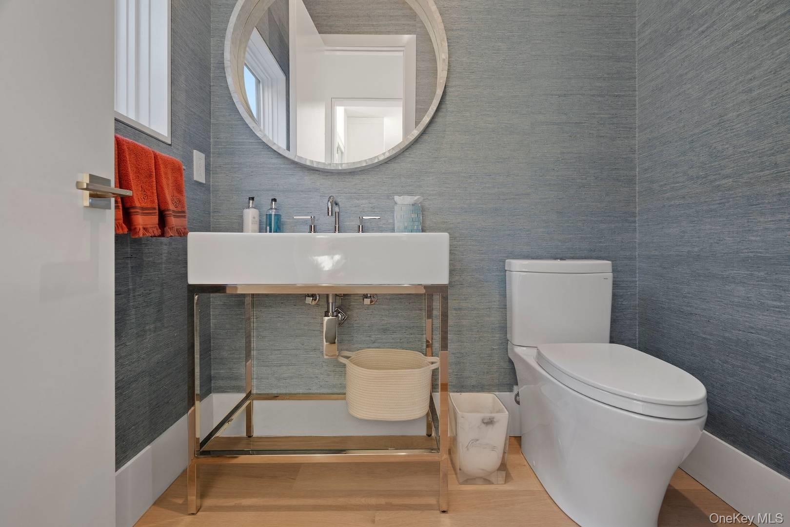 Bathroom with toilet, wood-type flooring, and sink