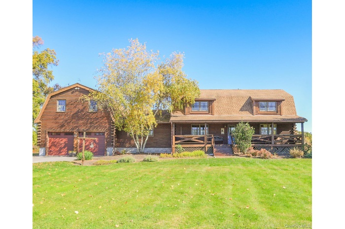 Welcome to 618 Clapp Hill Road. This charming log cabin offers timeless rustic appeal with its handcrafted timber exterior and inviting front porch.