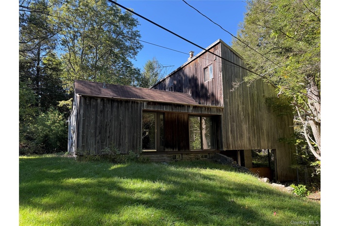 Exterior view of the front of the home with a lawn
