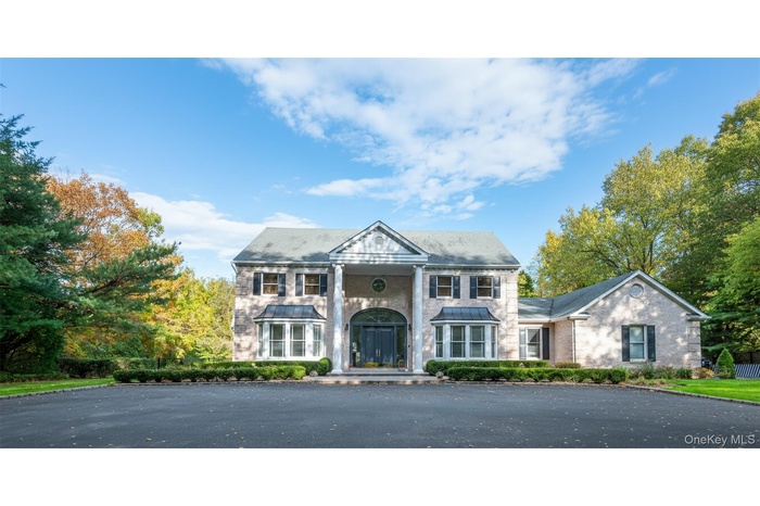 Greek revival inspired property featuring brick siding
