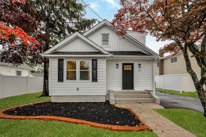 Bungalow with board and batten siding and a shingled roof