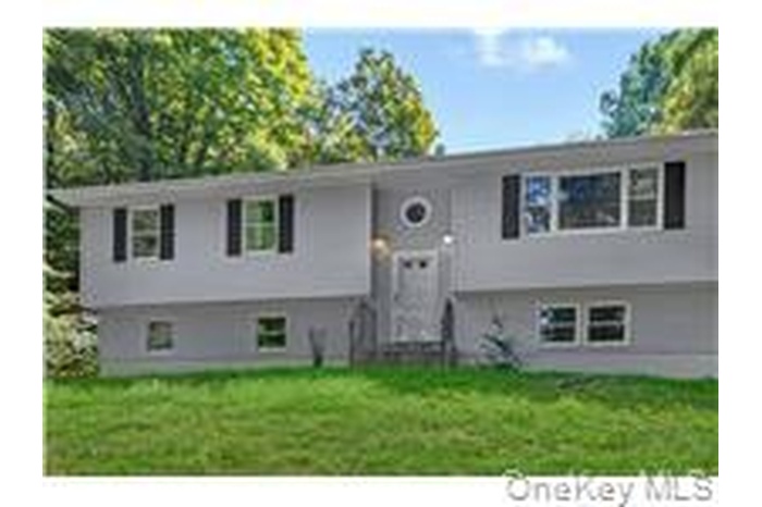 Raised ranch featuring a front lawn