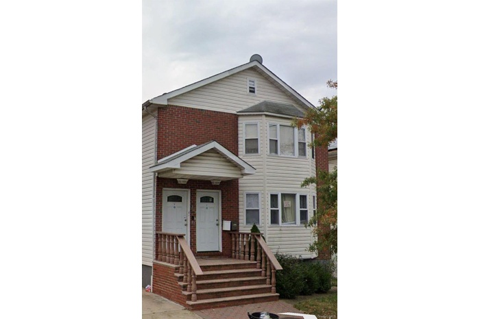Traditional-style house with brick siding