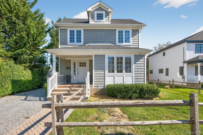 Traditional style home featuring a porch and a shingled roof
