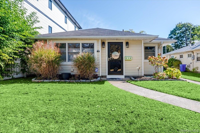 View of front of house with a shingled roof