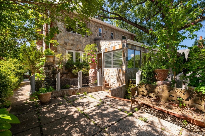 Front façade with a view of the heated enclosed porch