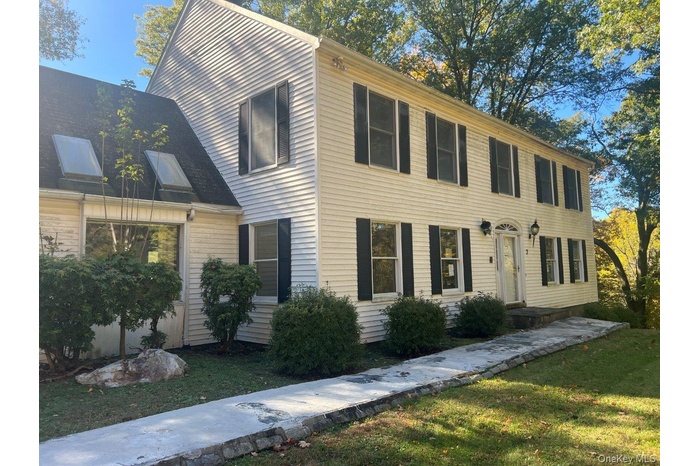 Colonial-style house with a front yard