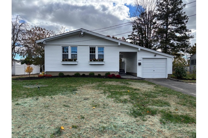 Single story home with asphalt driveway and a garage