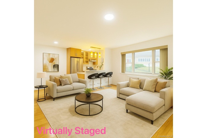 Living area with light wood-style flooring and recessed lighting