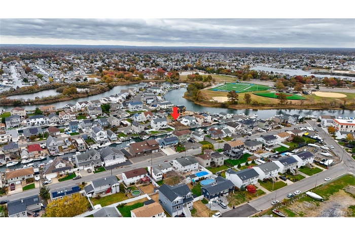 Aerial overview of property's location with nearby suburban area