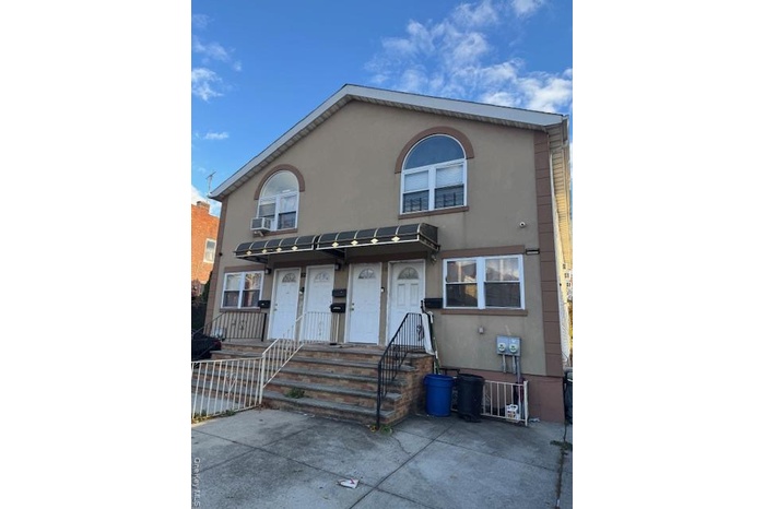 View of front of house featuring stucco siding