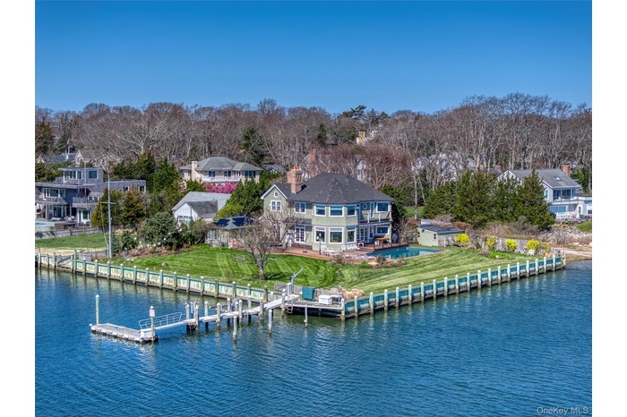 Dock featuring a lawn, a water view, and view of wooded area
