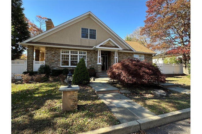 View of front of home featuring a stucco and stone facade