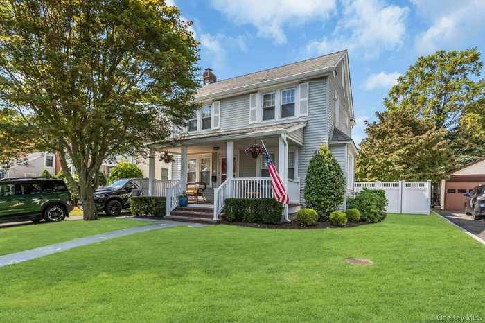 Traditional style home with covered porch and a chimney