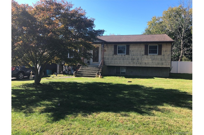 View of front of home with a shingled roof