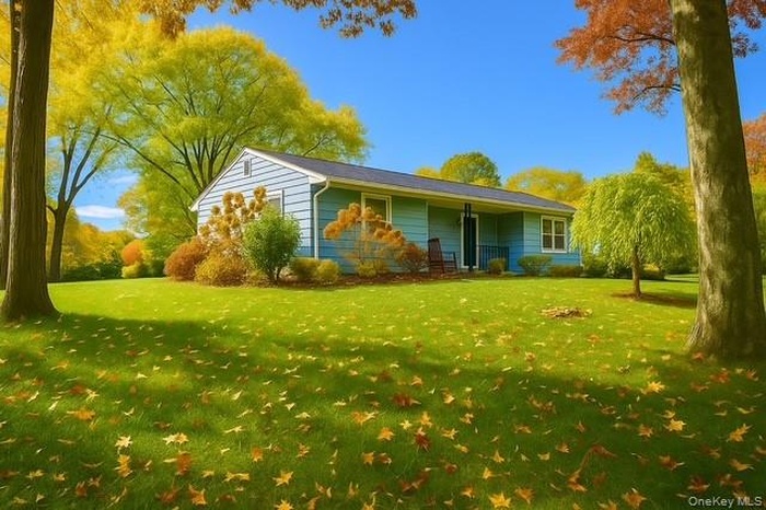 View of property exterior with a yard