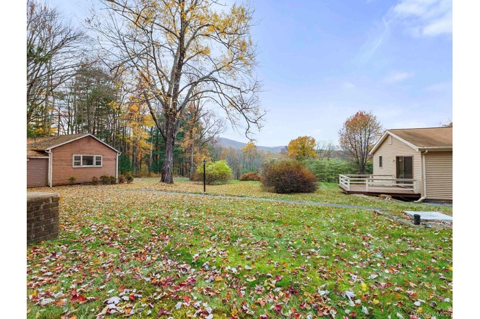 View of green lawn with a wooden deck