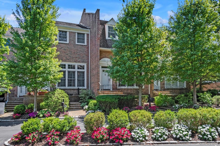 View of front facade with brick siding and roof with shingles