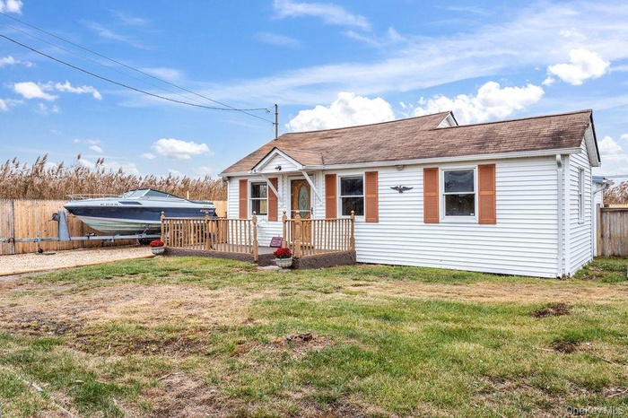 View of front facade featuring a wooden deck