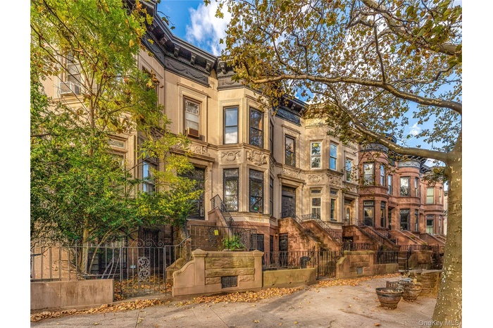 View of building exterior with a fenced front yard