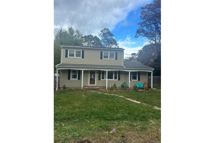 Traditional-style house with covered porch