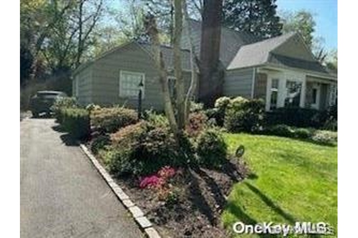 View of side of home featuring a yard