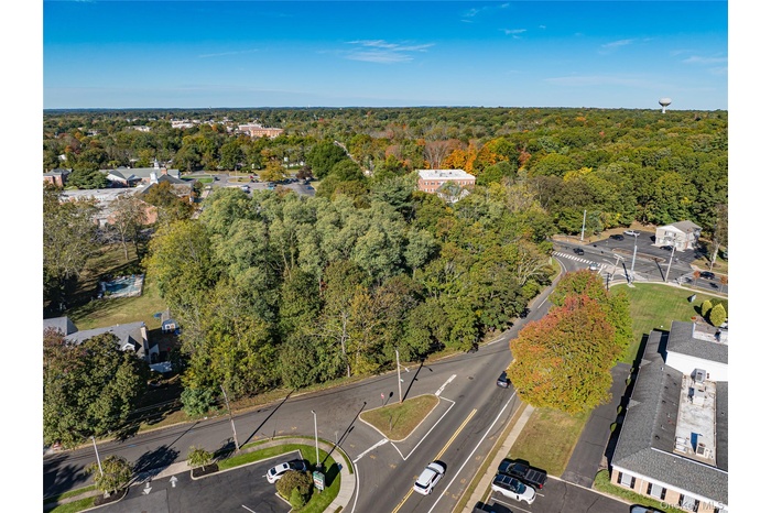 Aerial overview of property's location with a heavily wooded area
