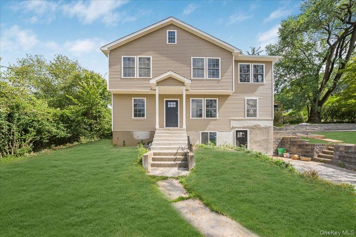 View of front of property with a front lawn