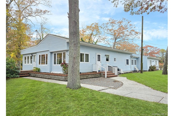 Rear view of house with a yard and entry steps
