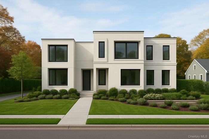 Contemporary house featuring stucco siding and a front yard