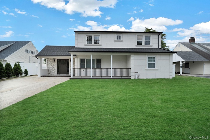 View of front of home featuring a porch, a shingled roof, and driveway