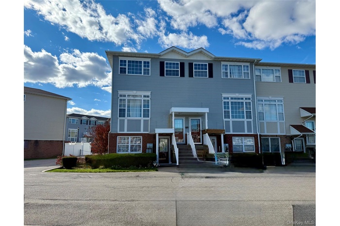 Traditional-style home featuring brick siding