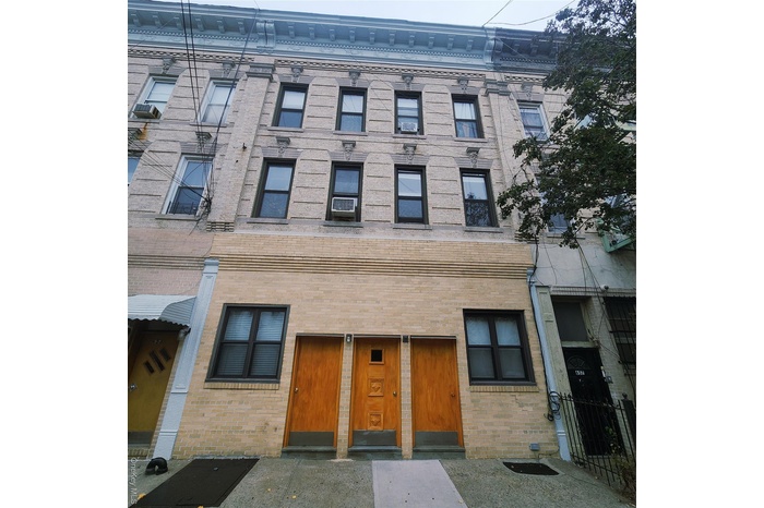 View of front of property featuring brick siding