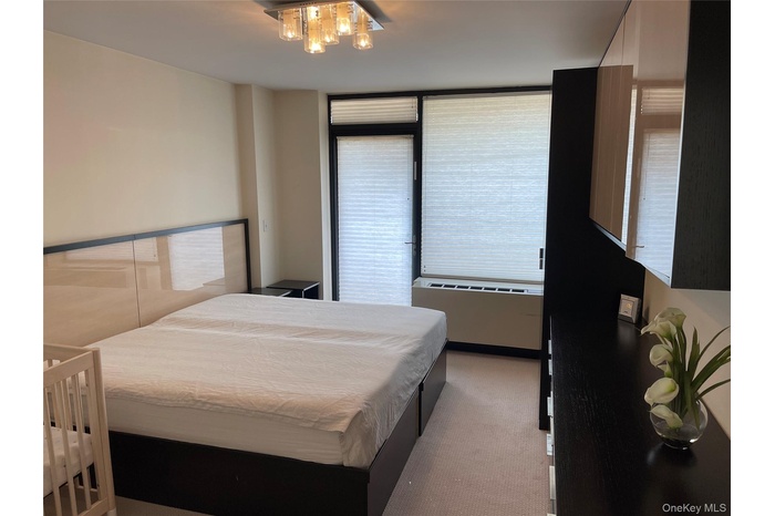 Bedroom with light colored carpet