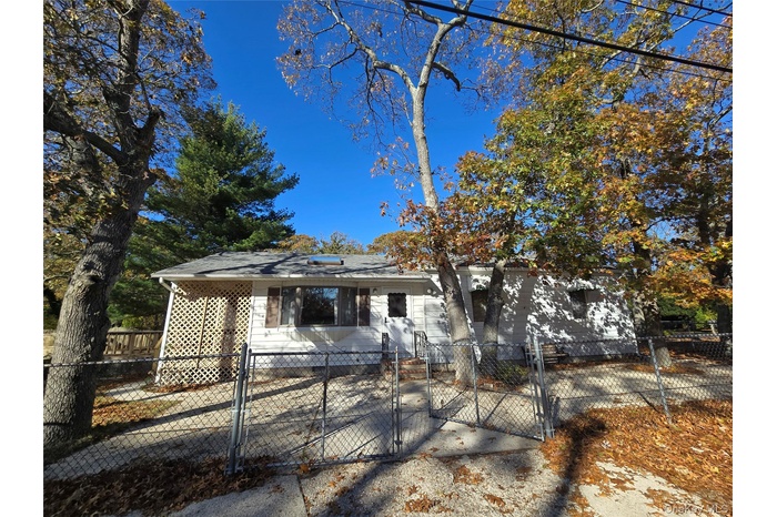 Bungalow-style home with a gate and a fenced front yard