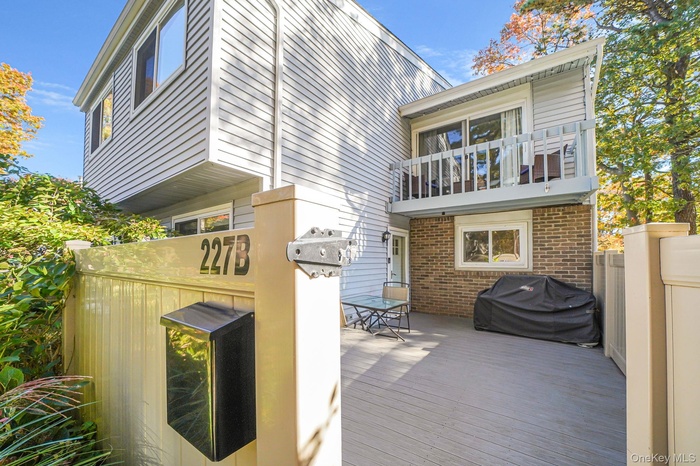 Rear view of property featuring brick siding and a balcony