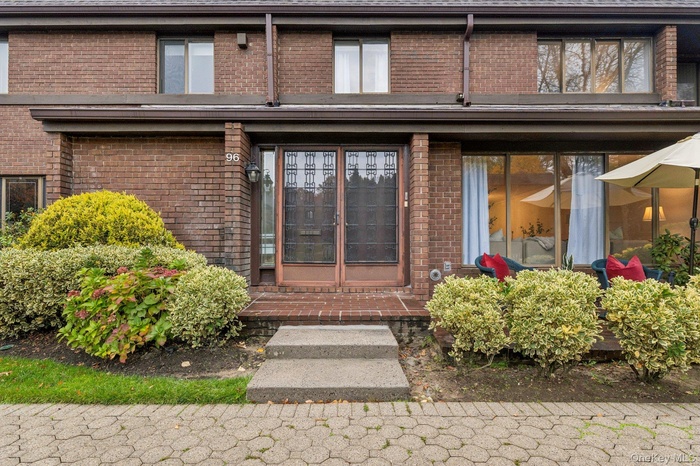 View of exterior entry featuring brick siding