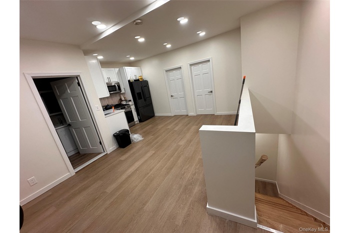 Living area with recessed lighting and light wood finished floors