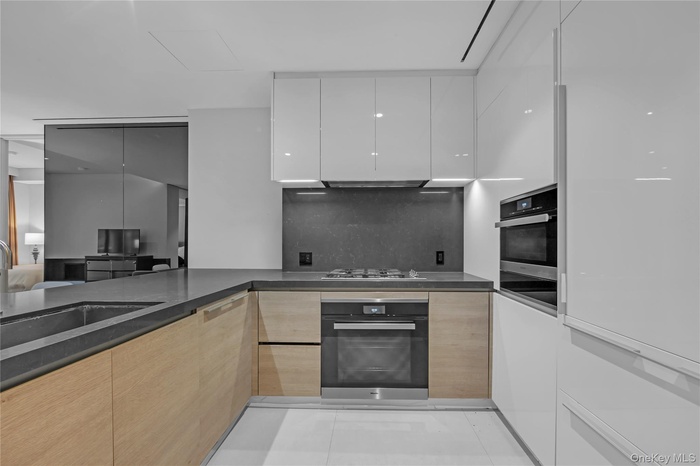 Generously sized Varenna Poliform-designed chef’s kitchen boasts Miele and Sub-Zero appliances